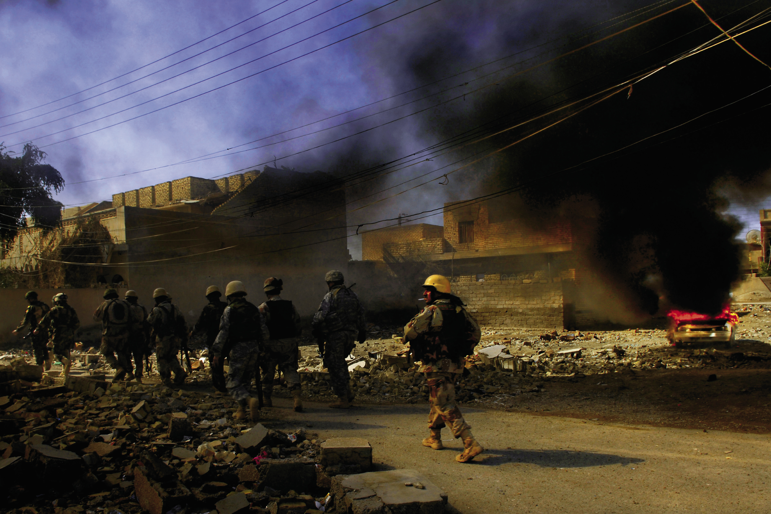 March 2, 2007: Iraqi army soldiers  from the 2nd Battalion, 2nd Brigade,  5th Division walk past a possible vehicle-born I.E.D., which was destroyed in Baqubah, Iraq.