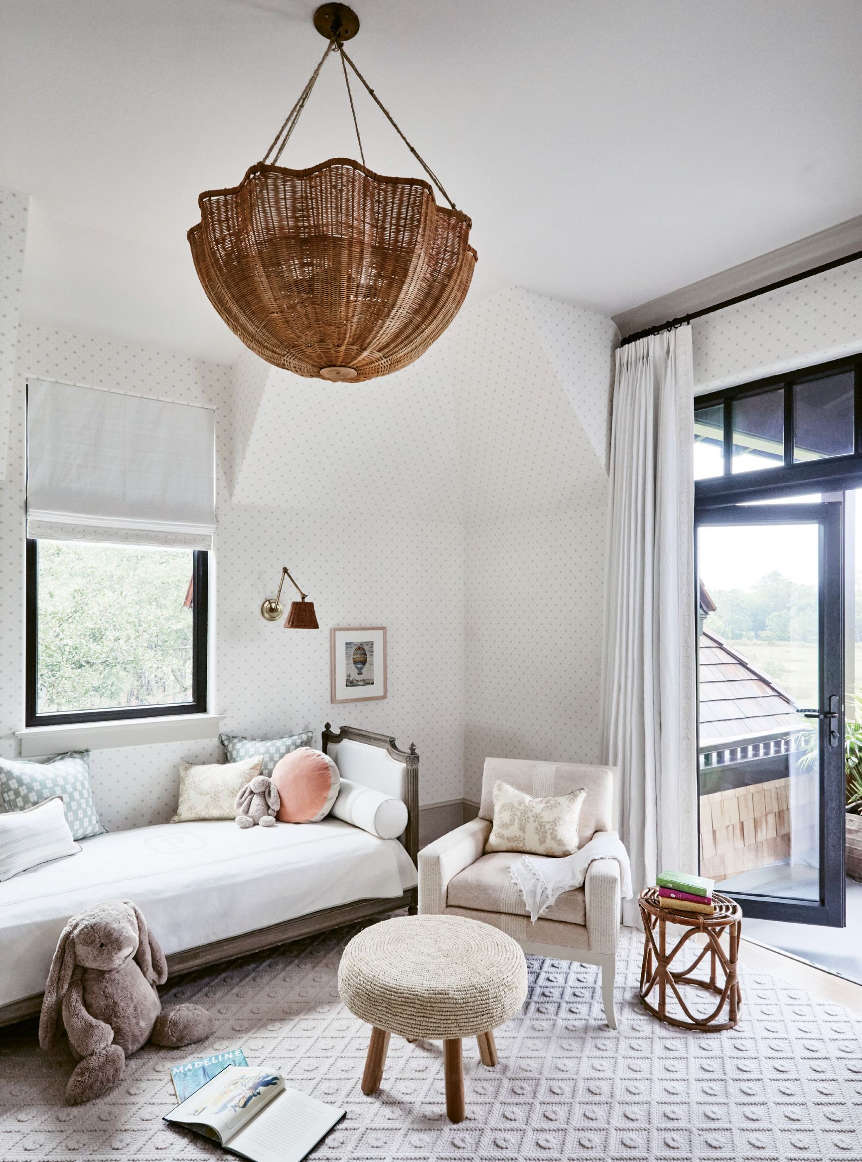 SUBTLE CUES: Upstairs, colors progress throughout the bedrooms. The soft monochromatic nursery features a Donghia wallpaper dotted with taupe stars.