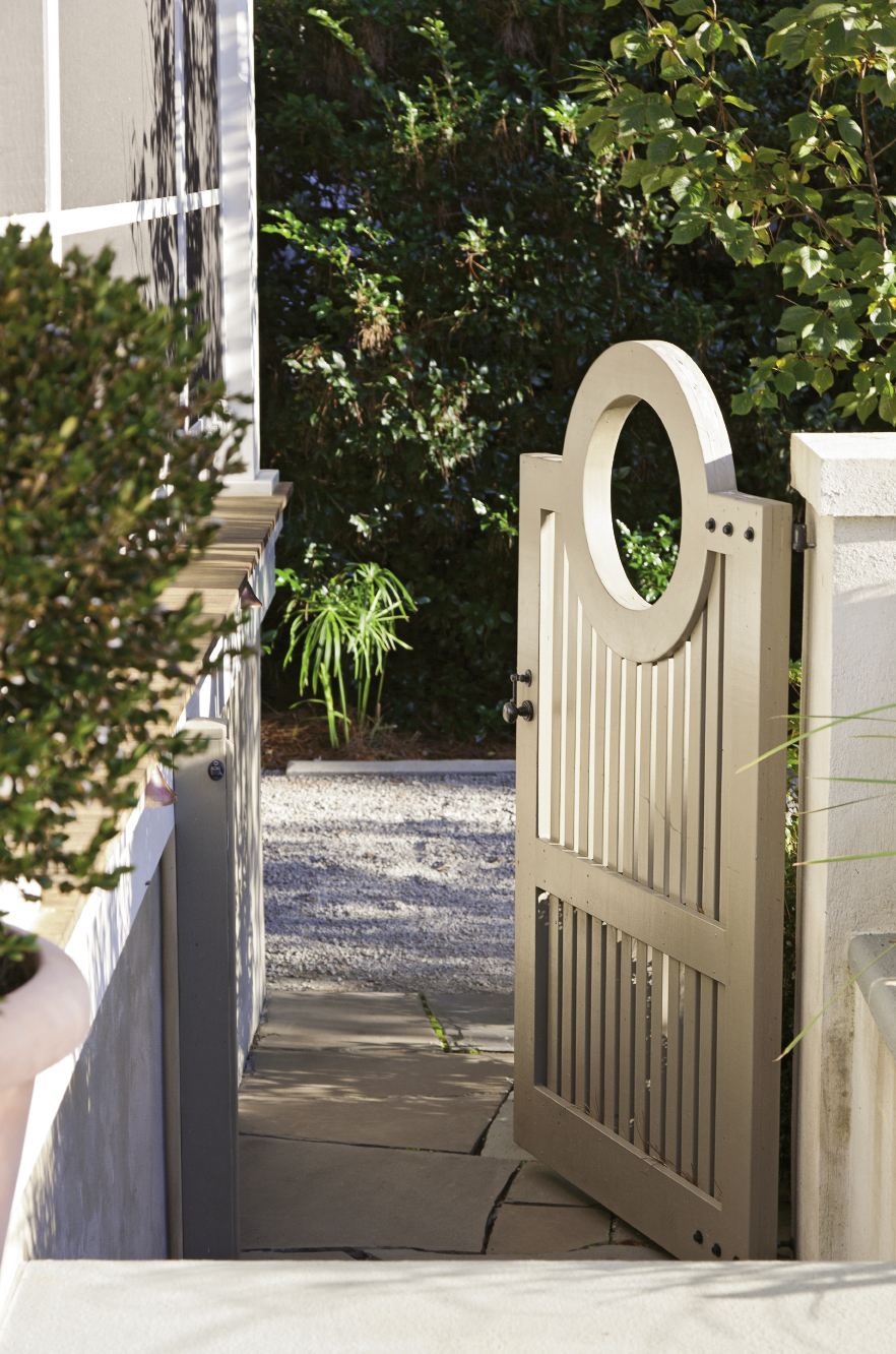 The back gate leads into a verdant haven in the Old Village, where a subtly dramatic garden awaits, including rows of undulating boxwoods and “hardy gardenia” azaleas.