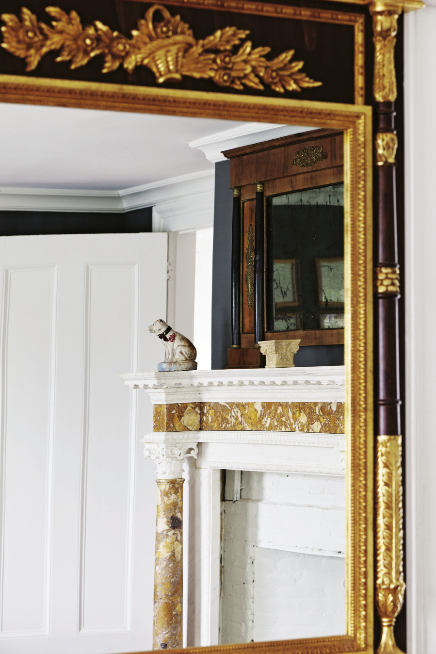 In a third-floor guest room, a mantel with two styles of marble brought over from a house in Gubbio, Italy.