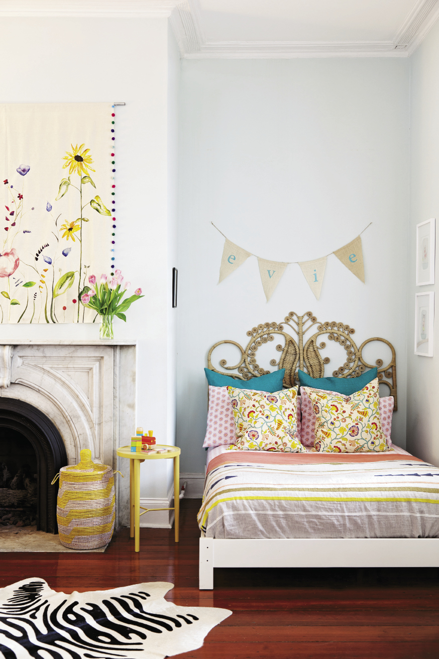 Sweet Dreams Evie’s palace is the largest room in the house. Art by Lauren’s friend Way Way Allen blooms over the mantel, and Evie originals make another gallery,