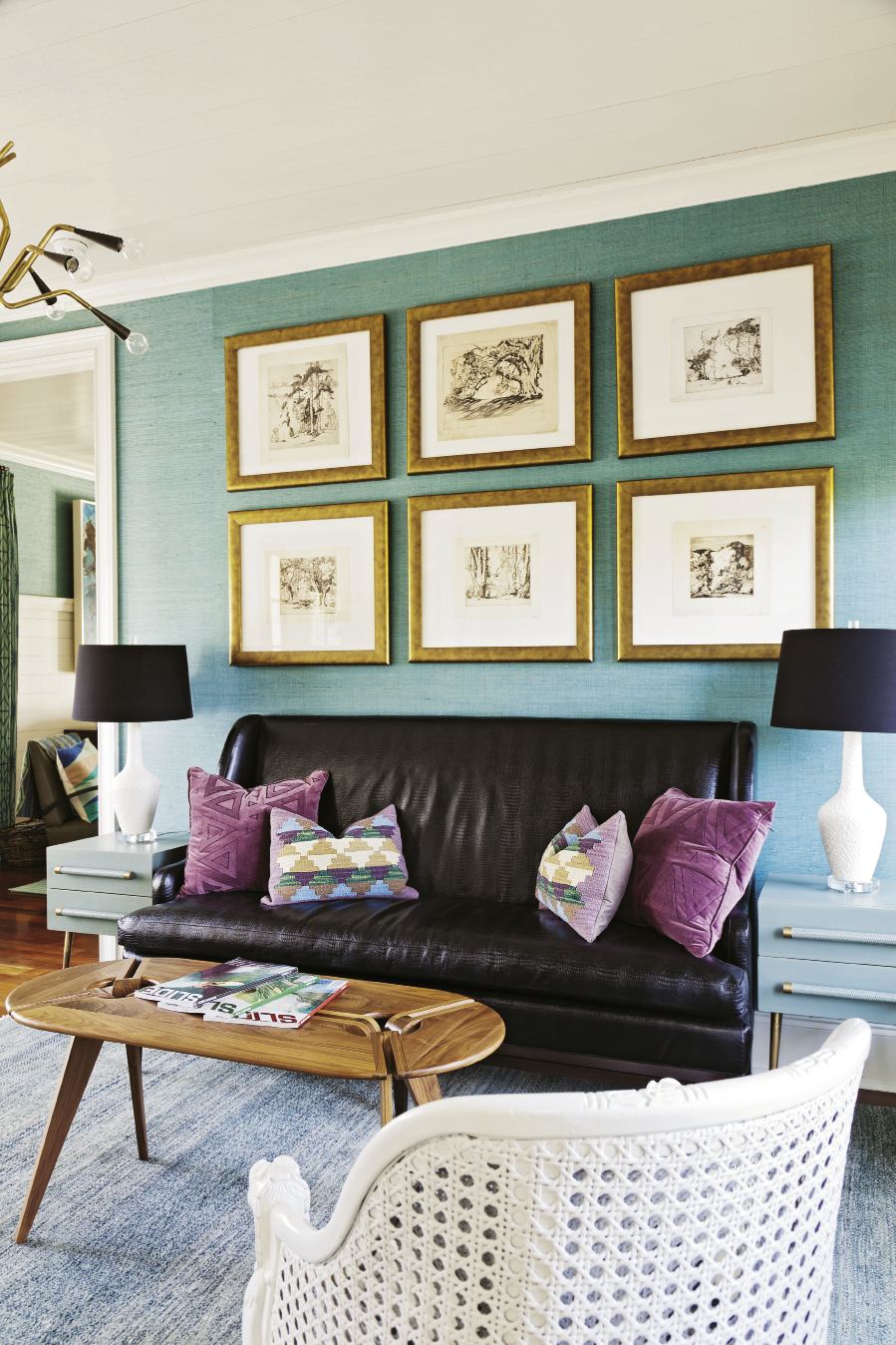 With its grass cloth wall coverings and accents of bronze and black leather, the mater bedroom’s adjacent sitting room feels a little bit coastal, a little bit rock-and-roll.