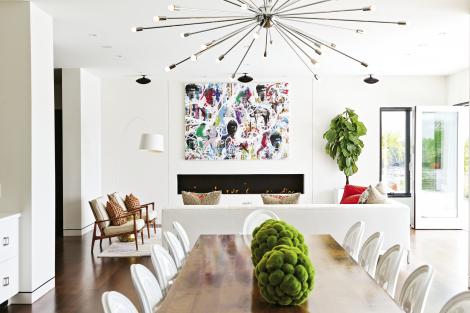 Room with a View: A mixed media work by Ben Hollingsworth hangs over the linear fireplace in the living room. The armchairs are Midcentury Danish pieces by IB Kofod Larsen with a 1960s Hollywood Regency brass cocktail table.