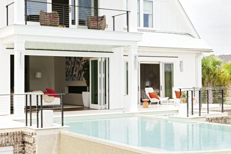 Open-door Policy: Accordian-style doors fold open along the rear of the house, where the living room steps out to the pool.