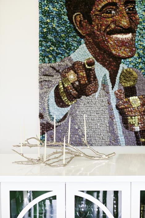 Molly B. Right collage of Sammy Davis, Jr., and a Sputnik starburst chandelier headline the dining room, where Deidre designed the table to seat 12.