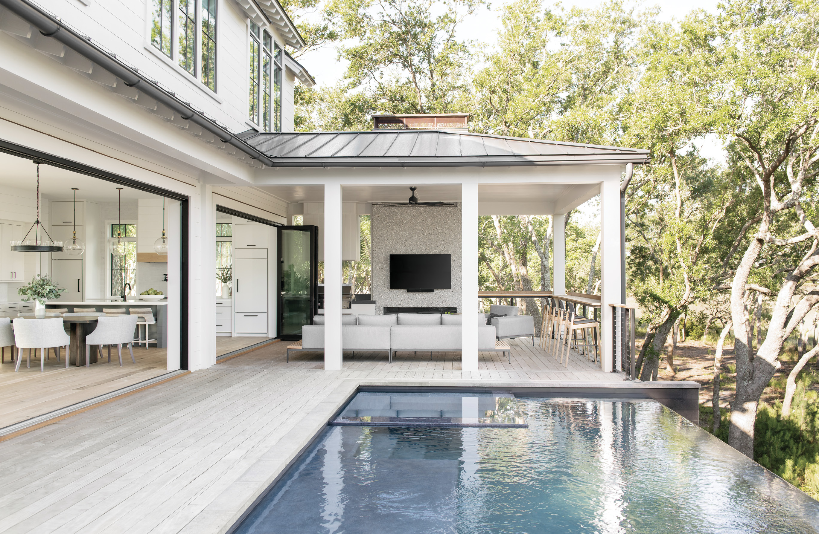 Cool Views: The outdoor living room and Gloster loungers offer prime seating next to the infinity pool installed by Aqua Blue Pools.