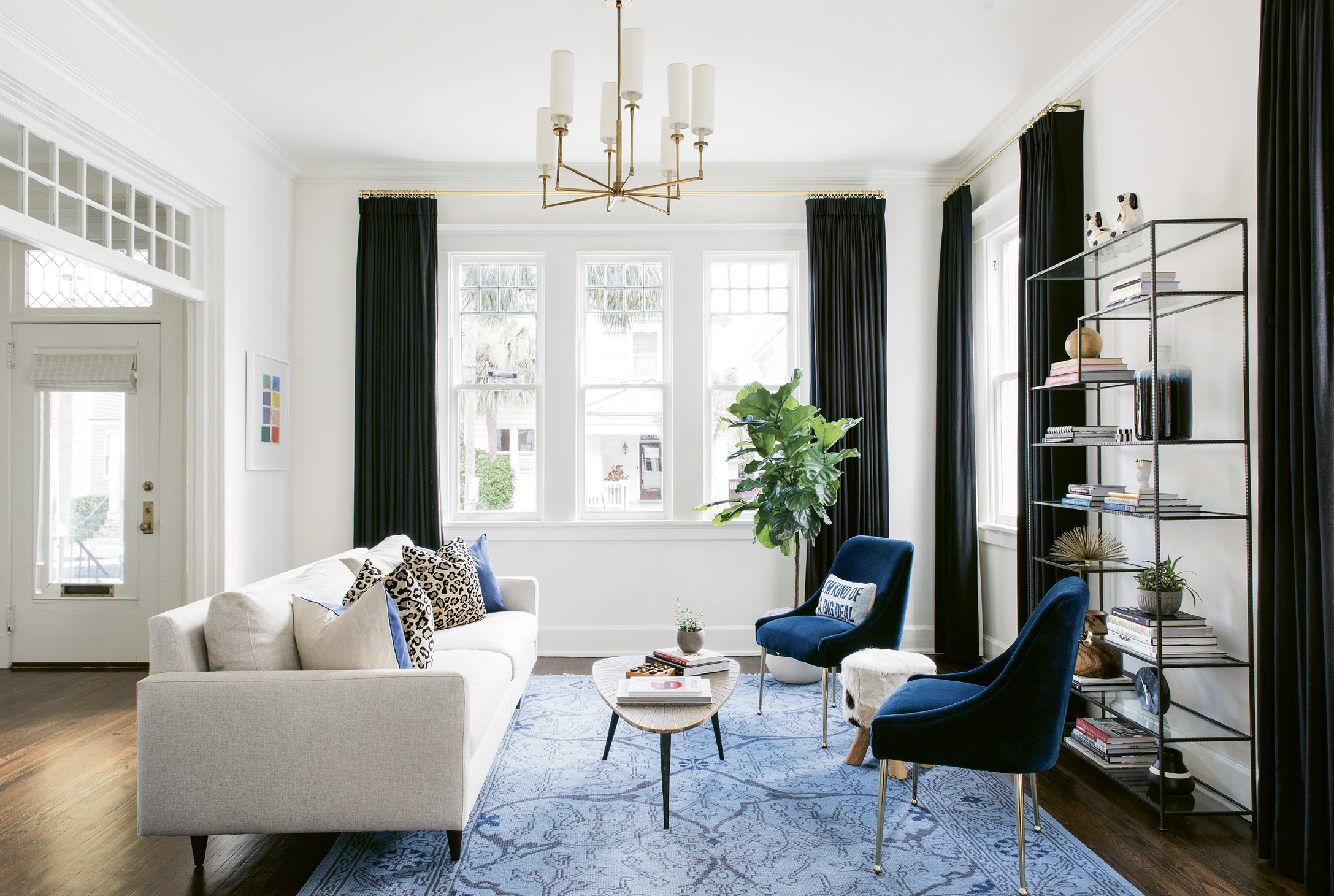 BOLD STROKES - Stay-at-home mom Alison—who studied fashion at the Art Institute of Charleston and worked in retail for years—craved a “fun, glamorous, and definitely not too serious” design, says Lenox. In the light-filled living room, a mid-century modern sofa from Room and Board is glammed up by Scalamandré leopard print and Jonathan Adler blue velvet pillows.