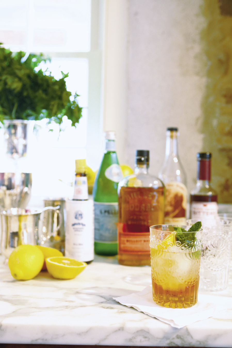 They suggest preparing a signature cocktail or punch for a party, handing guests a drink when they arrive.