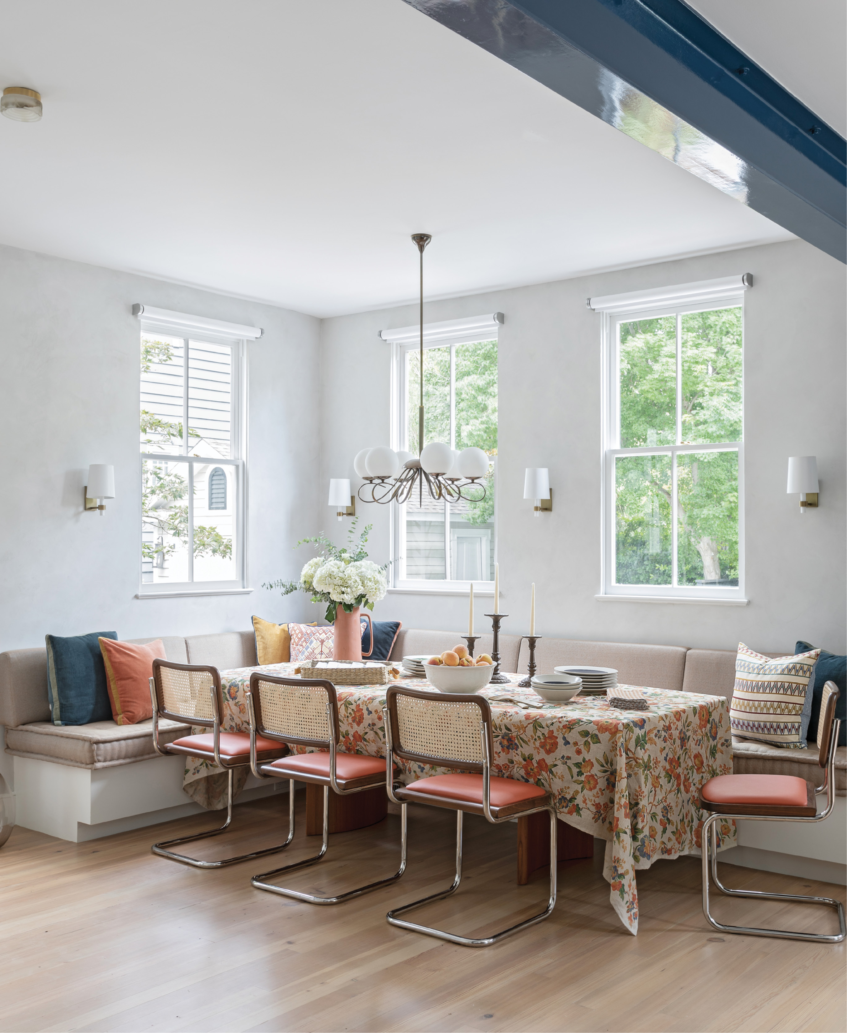 Beam It Up: Previously a screened-in porch, this dining space in the now-enlarged kitchen is the perfect place for the Newmans’s two daughters and their friends to hang out, or to gather the family for a meal. A long banquette extends the full width of the room providing plenty of space to spread out. Marcel Breuer-designed Cesca chairs add mid-century flair, and industrial motorized shades from J Geiger complement the room’s central feature—the architectural steel beam that traverses the space.