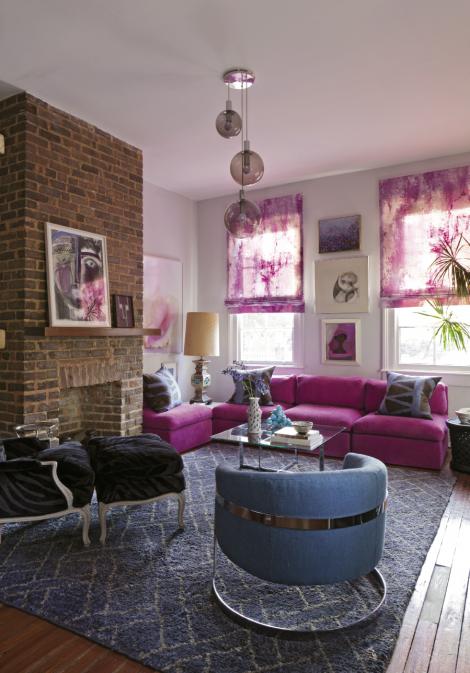 The sofa and Roman shades (fabric by Osborne &amp; Little) strike a vibrant tone against an indigo wool and jute rug from Moattar in Atlanta, a steel blue Milo Baughman chair, and a deep blue and black Bergere. The trio of lighting pendants is 1960s vintage.