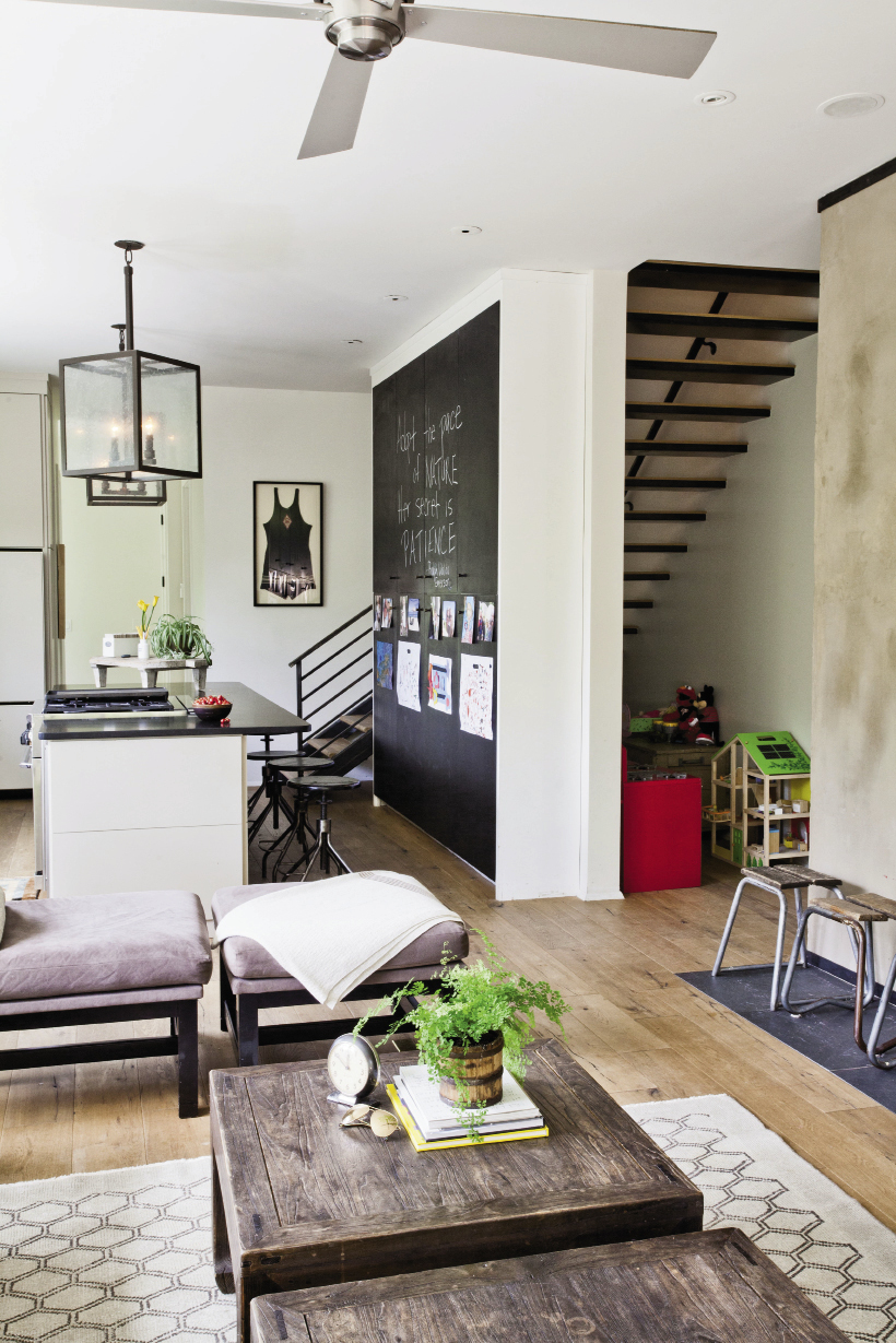 Monica and Alex dub the kitchen cupboards—covered in blackboard paint—a “savior.”