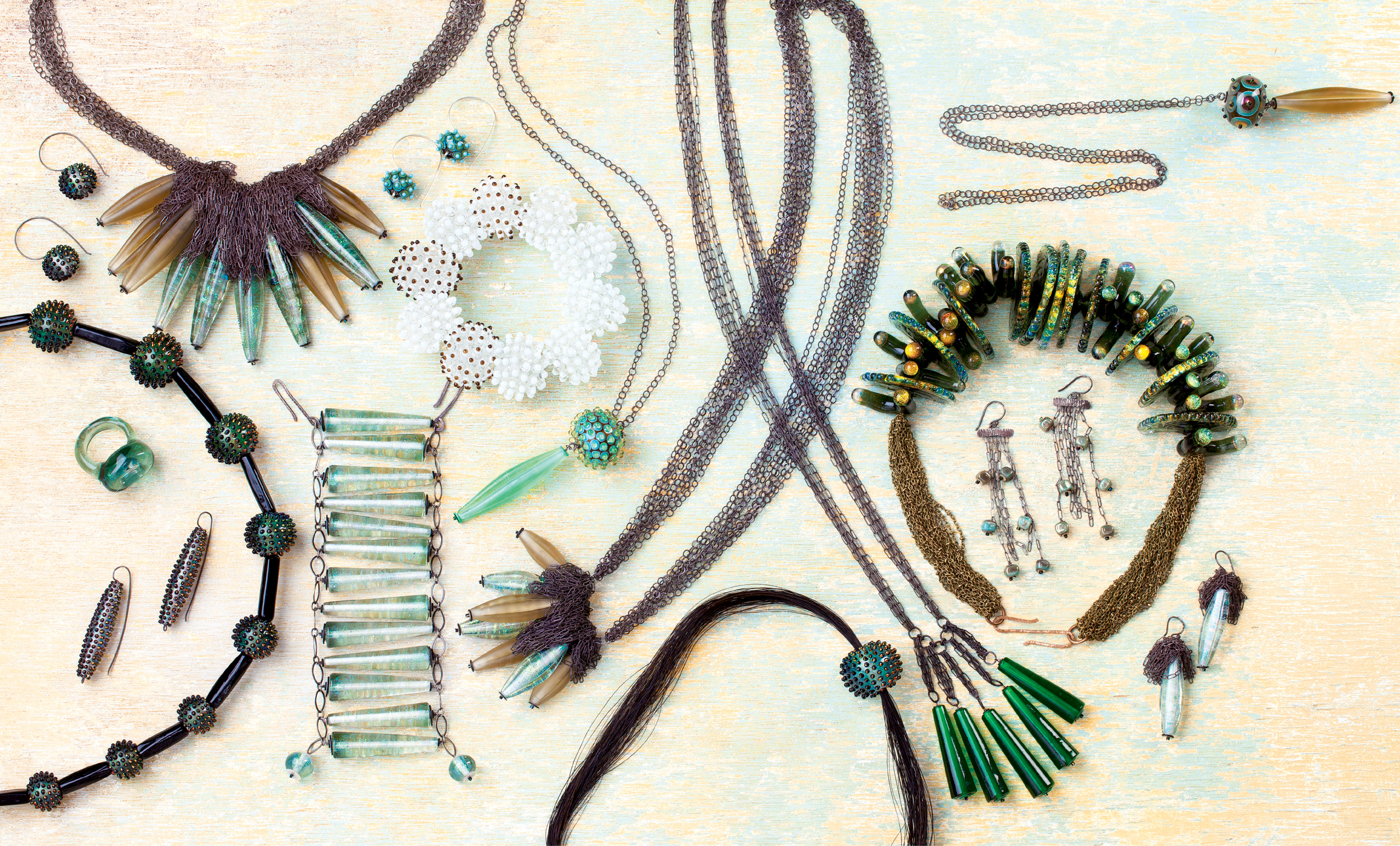 Kate Rothra Fleming: Inspired by natural elements, such as the flotsam she encounters while walking local beaches or seed pods littering the Central American rainforest, where she and her husband live part of the year, the artist re-envisions these forms in glass. Primarily self-taught, the art teacher-turned-jewelry designer uses flame to shape glass—whether shiny, frosted, or iridescent—and connect metals, creating wearable art resembling urchins, calyxes, mollusks, and more. “Many of my pieces come from a lifelong fascination with natural history and the unusual forms found there,” she says. Kate’s work is sold in galleries and at shows across the country, such as Atlanta’s American Craft Show, as well as katerothrafleming.com. But locals can peruse them, in season, at our very own Charleston Farmers Market.