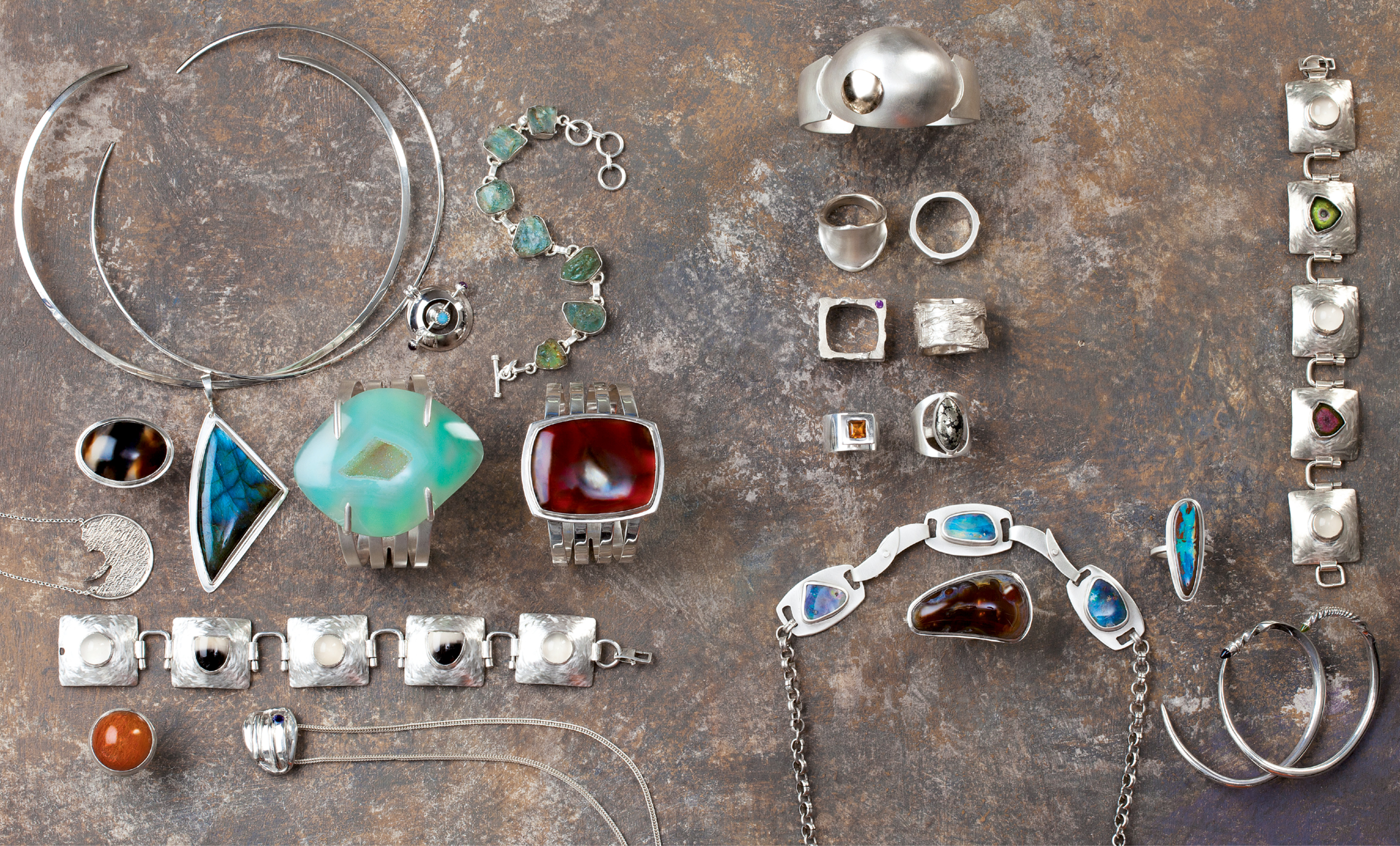 Angela Hall, Angela Hall Designs: Intriguing gemstones often drive the clean-lined designs of the College of Charleston grad, who continued her arts education at Savannah College of Art and Design, The Museum School of Fine Arts in Boston, and the Haystack School in Maine and launched her eponymous custom jewelry line in Charleston in 2000. Whether starting with Australian boulder opal, Brazilian piranha agate, sapphire, or watermelon tourmaline, she incorporates techniques in fine metals—forming, soldering, filing, piercing, reticulation, and casting—to create each piece. “My work embodies simplicity and a respect for the fundamental principles of design,” she explains. See her jewelry at Charleston Farmers Market, as well as at angelahall.net and angelahall1.etsy.com.