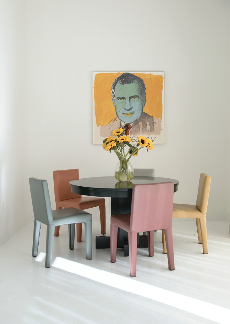 COLORFUL FRIENDS: Baldwin recalls hanging out with Andy Warhol in New York in the ’70s, and one of his original screen prints of Richard Nixon hangs above a lacquered green Roy McMakin table in this sitting area. Vintage Donghia leather chairs share the sunlight that streams in from the floor-to-ceiling windows.