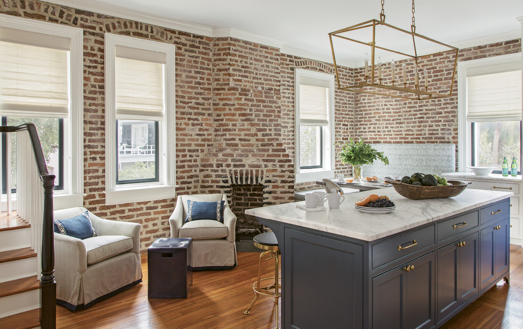 Brass repeated in the cabinet hardware, barstools, and large E.F. Chapman lantern chandelier from Circa Lighting ties it all together.