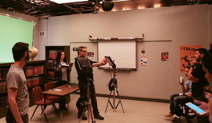 Bryan Curb (center) directs a shot inside “Jamestown University.”