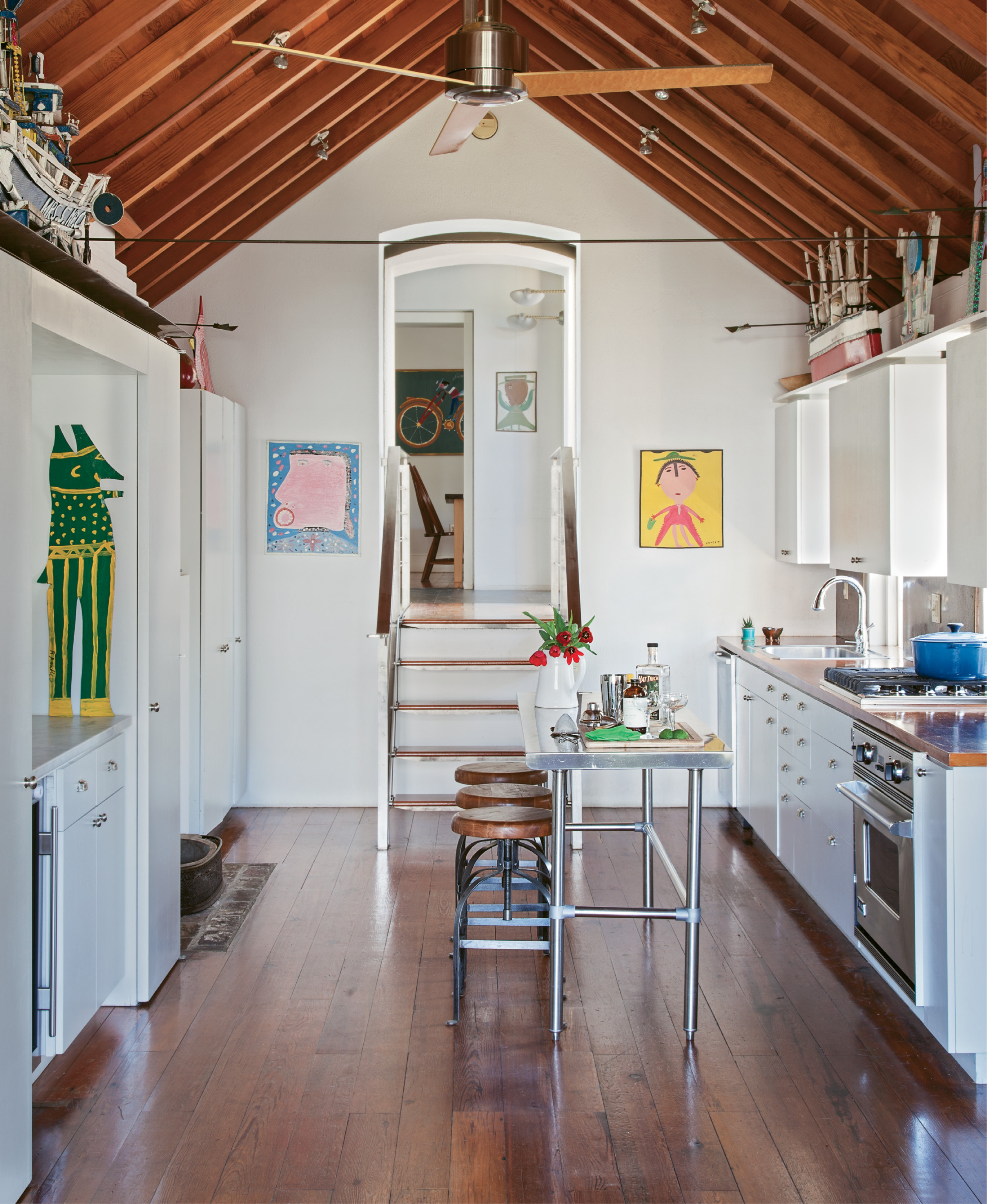 An avid baker, Scott spends a lot of down time here, surrounded by memories of old friends, including Alabama artist Mose Tolliver, whose works flank the arched doorway, and Louisiana’s J.P. Scott, whose carved and painted boats anchor above the cabinets.