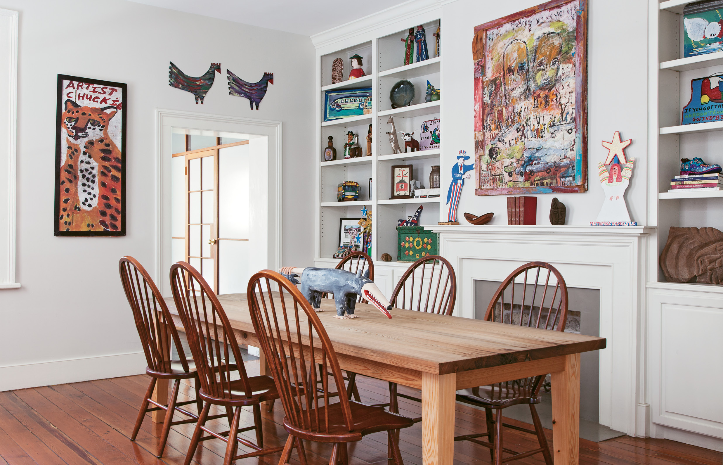 In the gallery-like dining room, built-ins display sculptures and smaller works