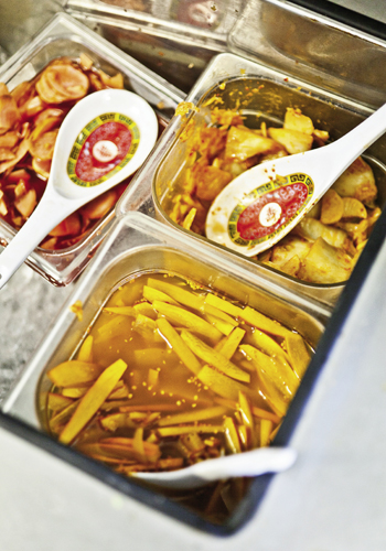 House-made, locally sourced condiments including pickled ginger and radishes from Dirthugger Farms