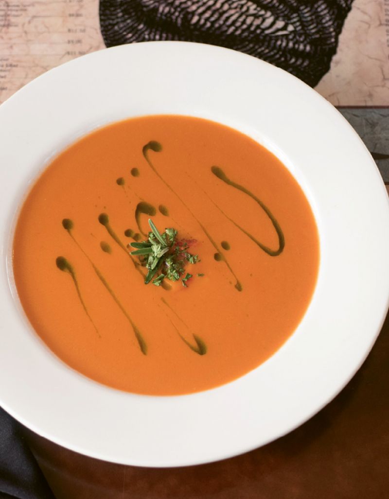 Bowled Over: Fresh rosemary sprigs, handpicked from Goulet’s backyard garden, top off tomato soup.