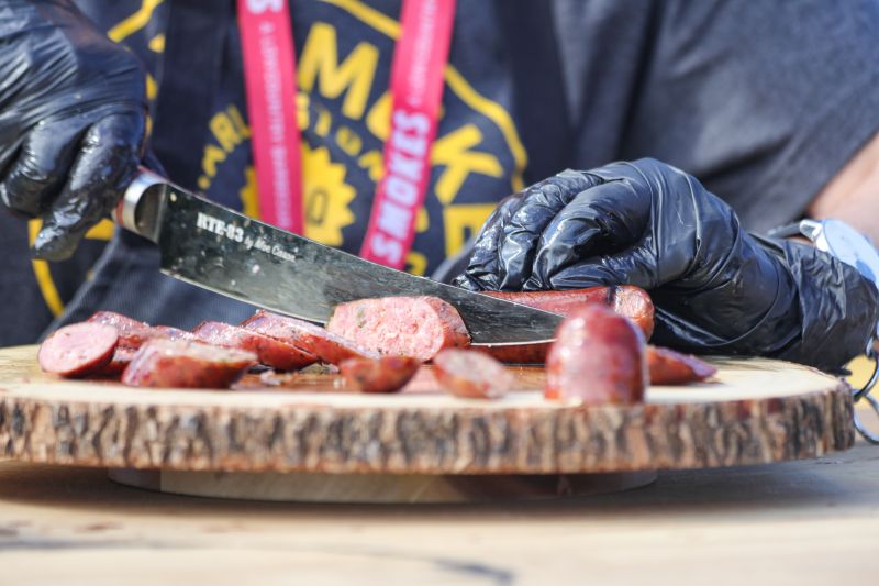 Sausage is sliced for shrimp and grits in the New School Village.