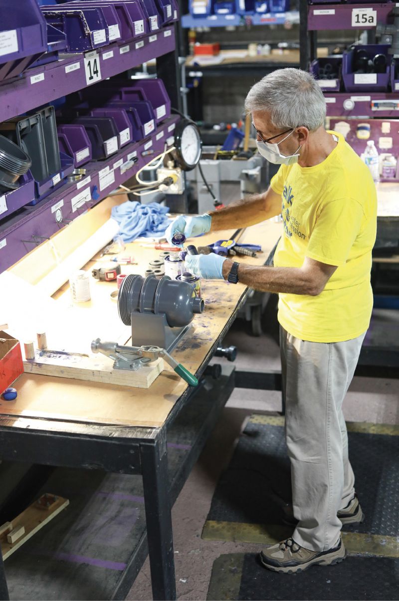 Building Solutions: At Water Mission’s North Charleston warehouse, volunteers man assembly line stations to carefully construct the nonprofit’s signature Living Water Treatment Systems.