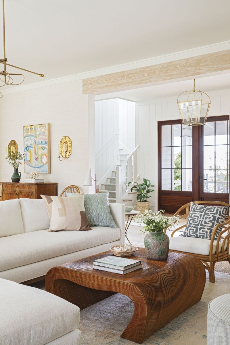 Organic Inspiration: “The Paglioccos wanted a calming, neutral color palette, and I was able to create interest by using different textures, including grasscloth wallpaper and various wood grains,” says interior designer Allison Elebash. “These materials give new homes warmth and character.” The waterfall pencil reed coffee table is from Chairish; the performance fabric-covered sectional, from GDC Home.