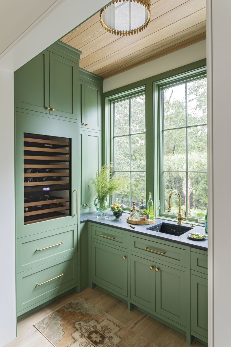 Sage Design: The nearby butler’s pantry, painted in Farrow &amp; Ball “Calke Green,” serves up extra prep space, ample storage, and showstopping looks. “[It] might be my favorite pantry ever,” says Elebash.
