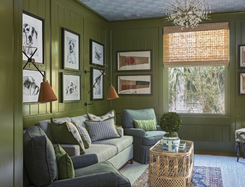 A mid-century Sputnik chandelier and whimsical dog prints by British artist Valerie Davide combine with a bamboo coffee table and leather sconces from Fritz Porter to add texture, depth, and interest to this comfortable, layered room.