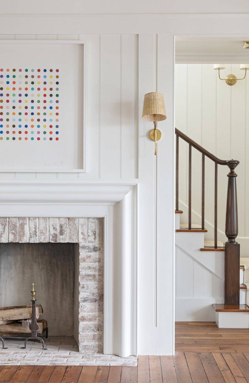 The mantelpiece frames the Damien Hirst spot painting.