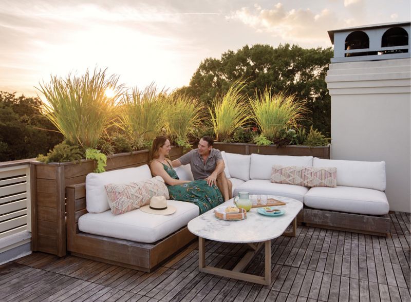 Happy Hours: Erin and Robert “Spence” Spencer in the rooftop lounge area, one of  two “must haves” when the couple decided to build a new home on their property near the Pitt Street Bridge. It’s a primo spot for toasting sunset, especially when Spence is making his signature margaritas.