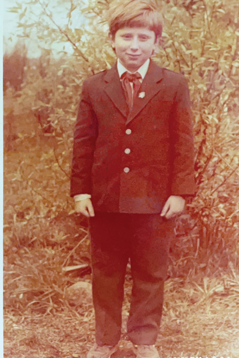 Yuriy in Belarus, in his school uniform with a red neckerchief and a pin of Lenin. “I was a Pioneer. Growing up in a communist country, we all had to be Pioneers,” he explains.