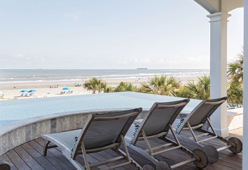 SOAK IT IN: When reinforcing and resurfacing the back deck’s heated infinity pool, Tom and Amy took care to match its color as closely as possible to the hues of the ocean.