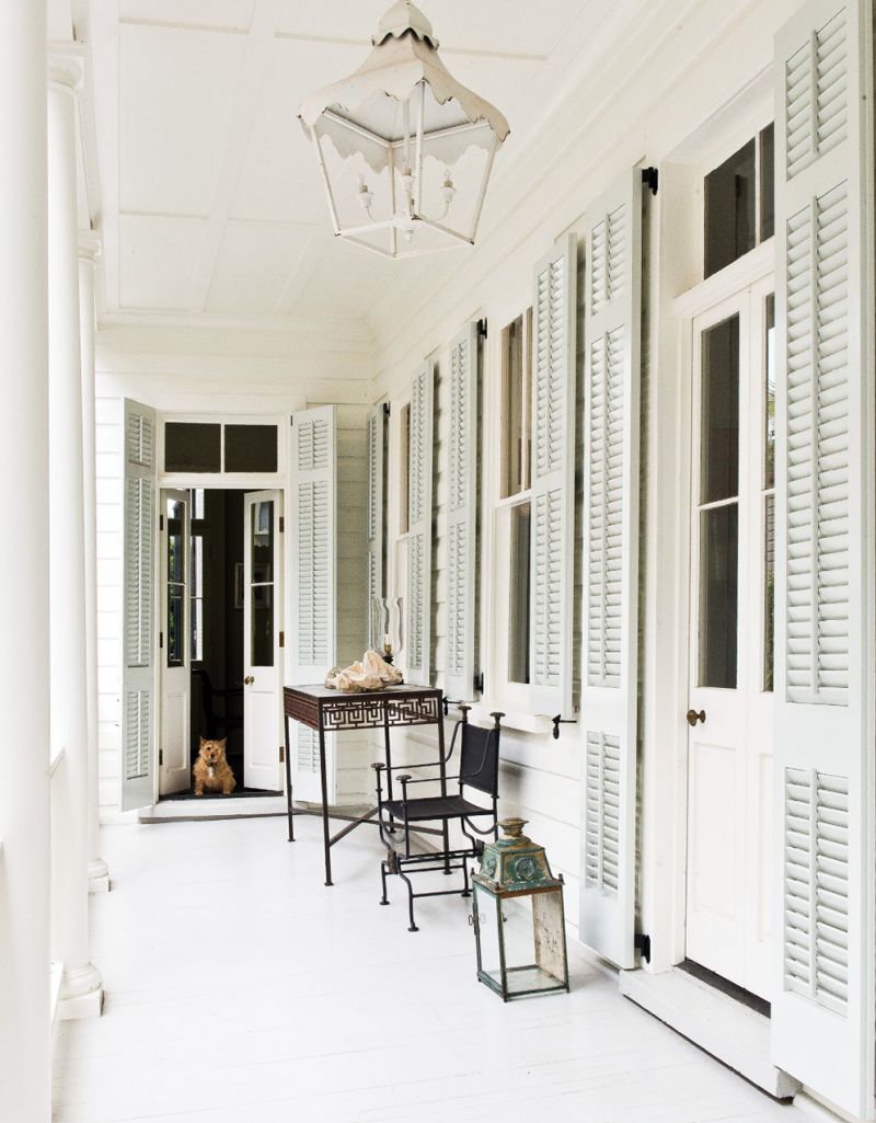 Porch-side doors and windows are equipped with louvered shutters designed to be adjusted according to the weather and the angle of the sun.
