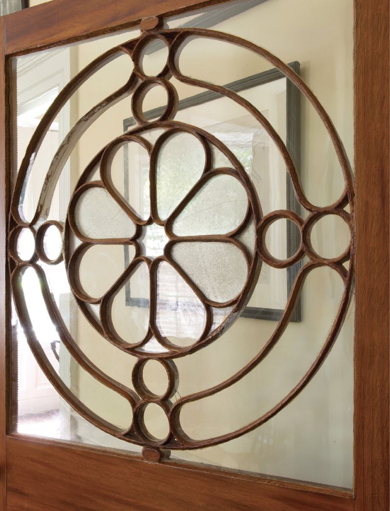 The door dividing the vestibule of the Nathaniel Russell House from the inner sanctum of family life and entertaining features an exquisitely crafted screen of carved wood and bentwood and antique glass.