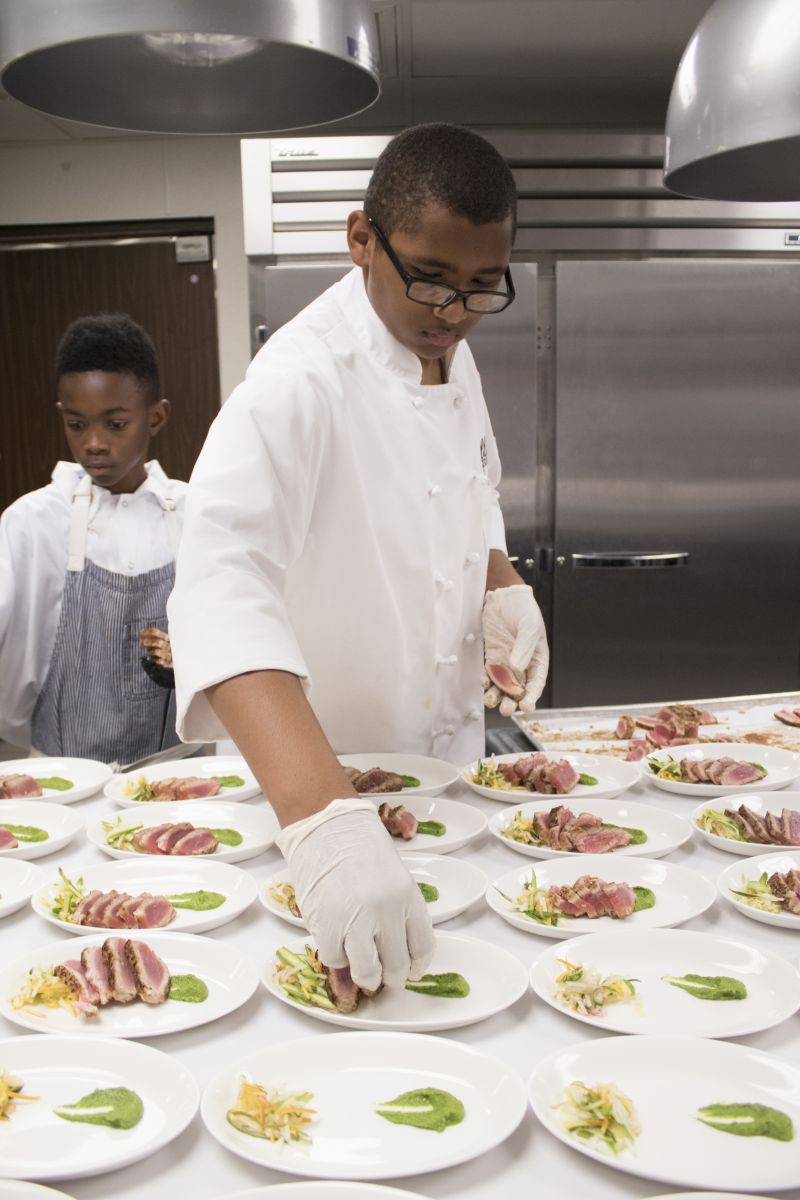 Aidan LaFave puts the finishing touches on the first course.