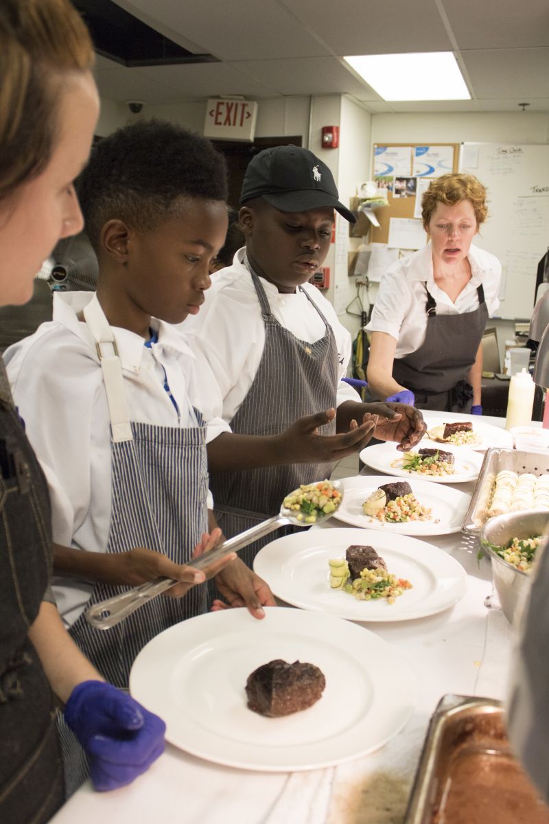 Robyn Fusto, Jaylen Jones, Jeremiah Venning, and Jill Mathias plate the fourth course.