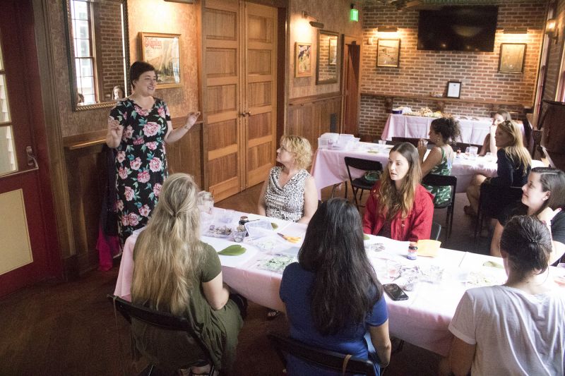 A master of the craft, Lauren Whiteside Mann instructs the class on the delicacy of flower pressing.