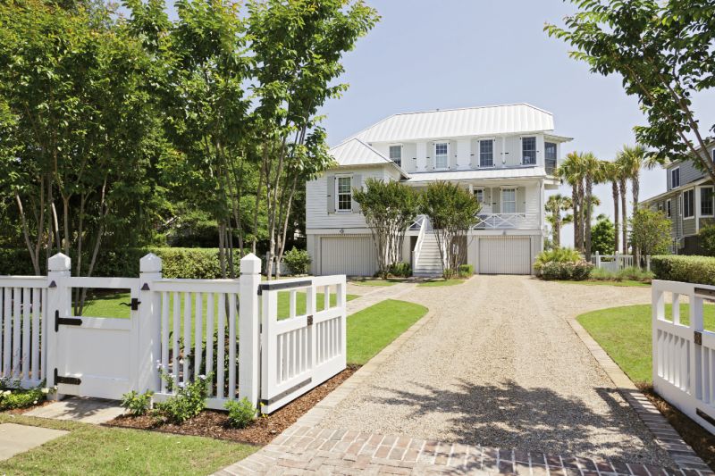Double Take: Architect Beau Clowney, working with builders Daly &amp; Sawyer, gave the street side of the house a smaller scale, in keeping with old Sullivan’s charm, while the beachfront façade is a classic, porch-perfect beach house.