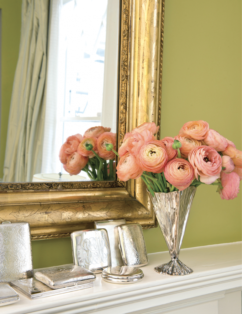 A gilt-framed mirror and silver card cases gleam like jewelry against chartreuse paint reminiscent of Georgian green.