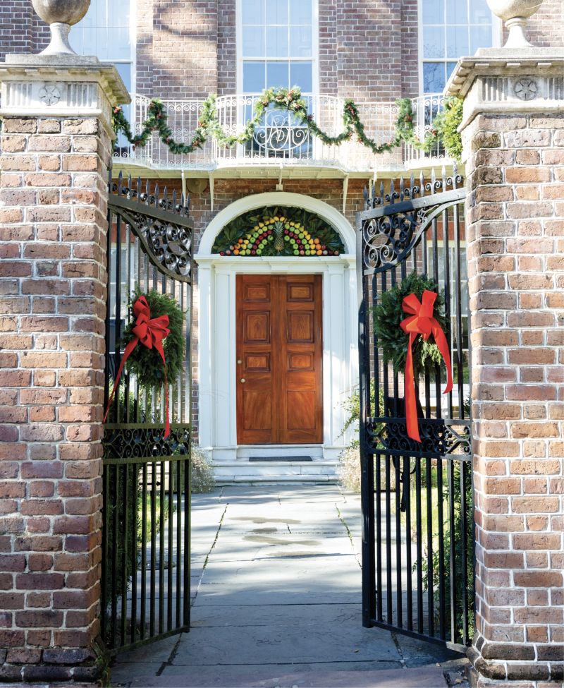 A Fruitful Welcome: The pineapple, the city’s symbol of hospitality, takes pride of place in this fanlight display, including faux apples and pears as well as podocarpus and magnolia leaves, at the Nathaniel Russell House Museum. Take an evening candlelight tour of the circa-1808 home and its traditional holiday decor.