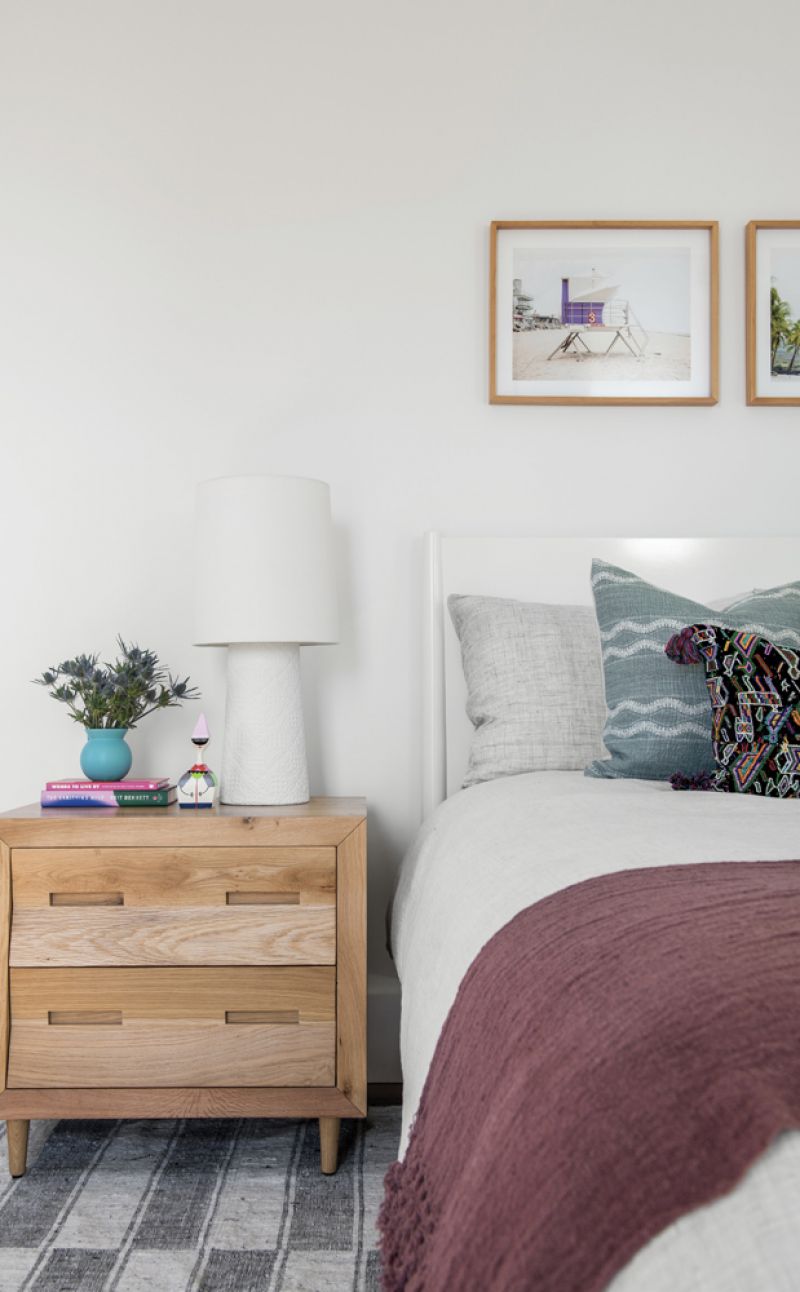 Pretty Pastels: Daughter Amelia’s bedroom and en-suite bath features a play of soft color and pattern, from the gorgeous pale blue vanity to the textured Anthropology rug and purple throw from a market in Peru.