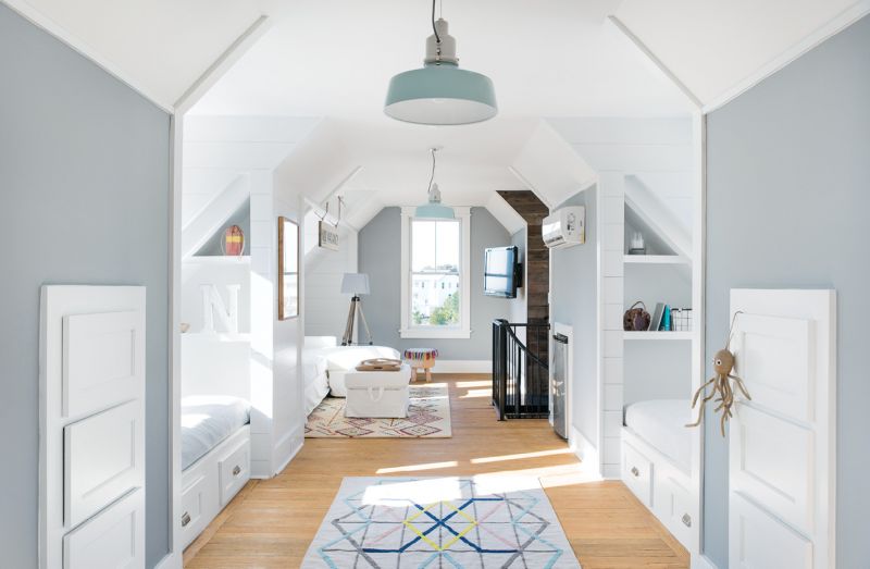 The second floor of the pool house boasts built-in beds in four cozy alcoves so overnight guests are always welcome.