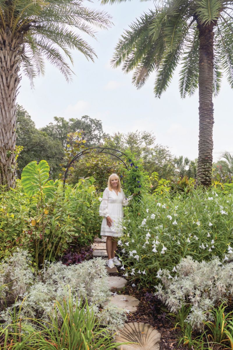 In Bunny Lloyd’s James Island backyard, ‘Powis Castle’ artemisia shines against white ruellia, while butterfly pea climbs the archway toward giant elephant ear, inviting visitors into a bloom-lined path-cum-hummingbird highway.