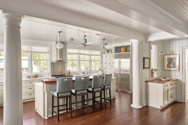 The kitchen was added as part of the 2009 renovation, creating more space and bringing in more light. Architect Steve Herlong incorporated original columns from the porch, relocated to make room for a bathroom suite. The AGA range adds an “old world” feel, says Jamie, and the island countertop is milled from beams reclaimed from the home, tying the old with the new.