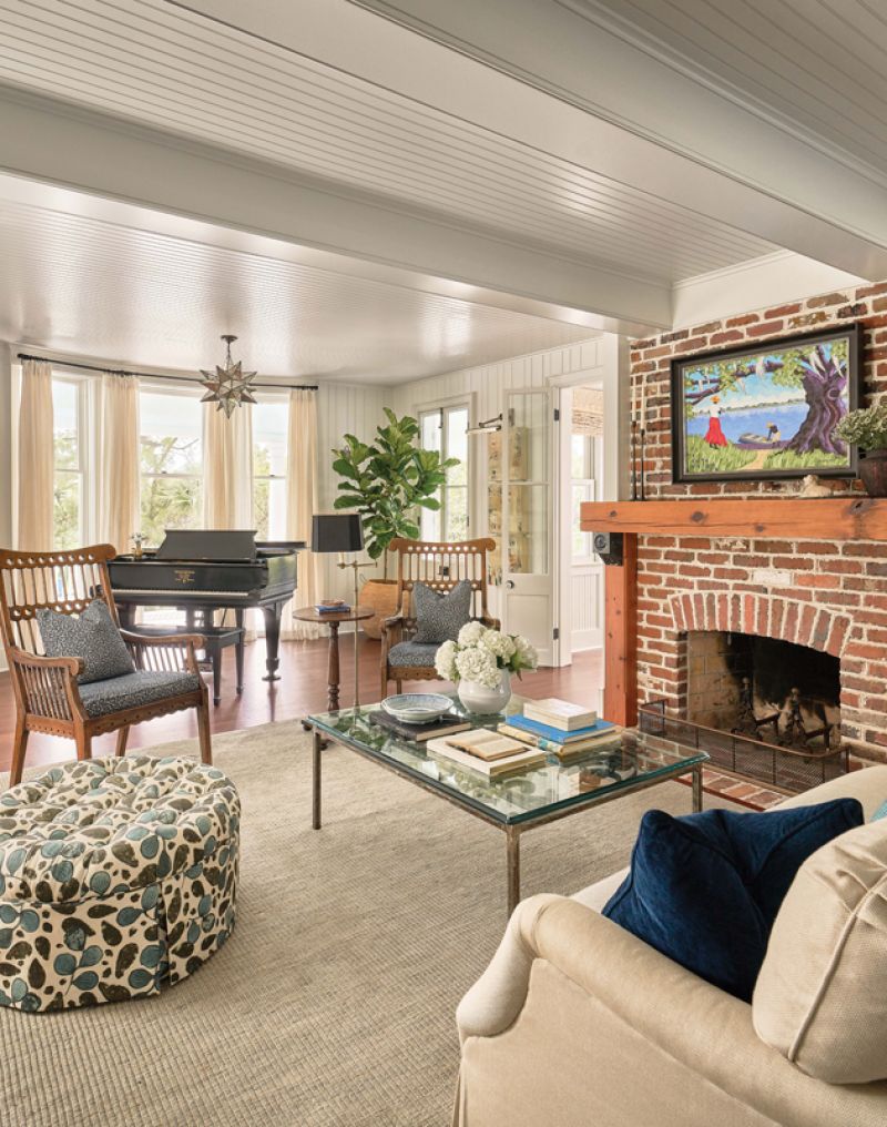 The mantelpiece and brick fire surround were added in the second renovation using heart of pine and brick original to the home. The painting above the fireplace is by David.