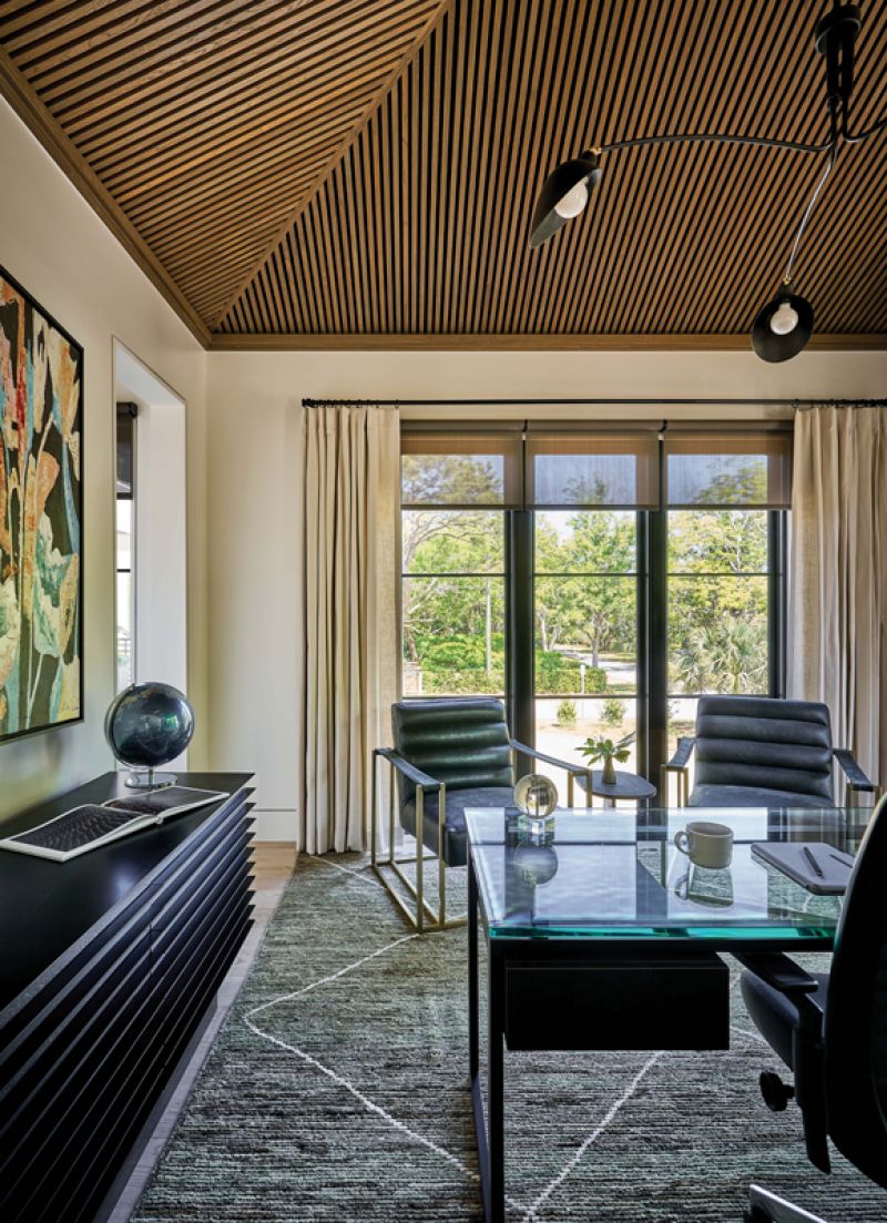 Steely Style: The office occupies one corner of the home and is highlighted by a stunning wooden slatted ceiling. Here, the black accents of the design, including a Noir console and pendant from Leo by Troy, merge to create a masculine feel.