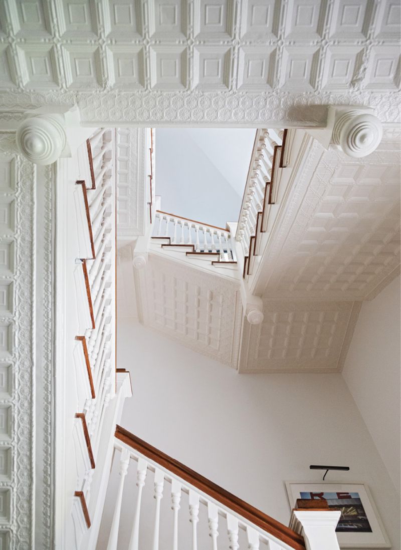 Tin Soldiers: The original patterned “tin” ceilings are a beloved feature of the house, best highlighted by this impressive view up the central staircase. The material was commonly used in the 19th century as an alternative to decorative plaster ceilings, and each room has a different pattern. Made from steel sheet metal, tin ceilings were considered more durable and, crucially, more fireproof. It was also easier and cheaper to install than decorative plaster.