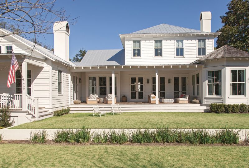 Past Perfected: Architect Beau Clowney designed the house for Jenny and Joe Keenan when daughter Lily, now 13, was still in the womb, and Jay, 14, just a toddler. The horseshoe shape allowed for a large family room (pictured above to the left with its own porch) looking out over the Old Village. That space was designed as a homage to a former sweet shop that once occupied the lot.