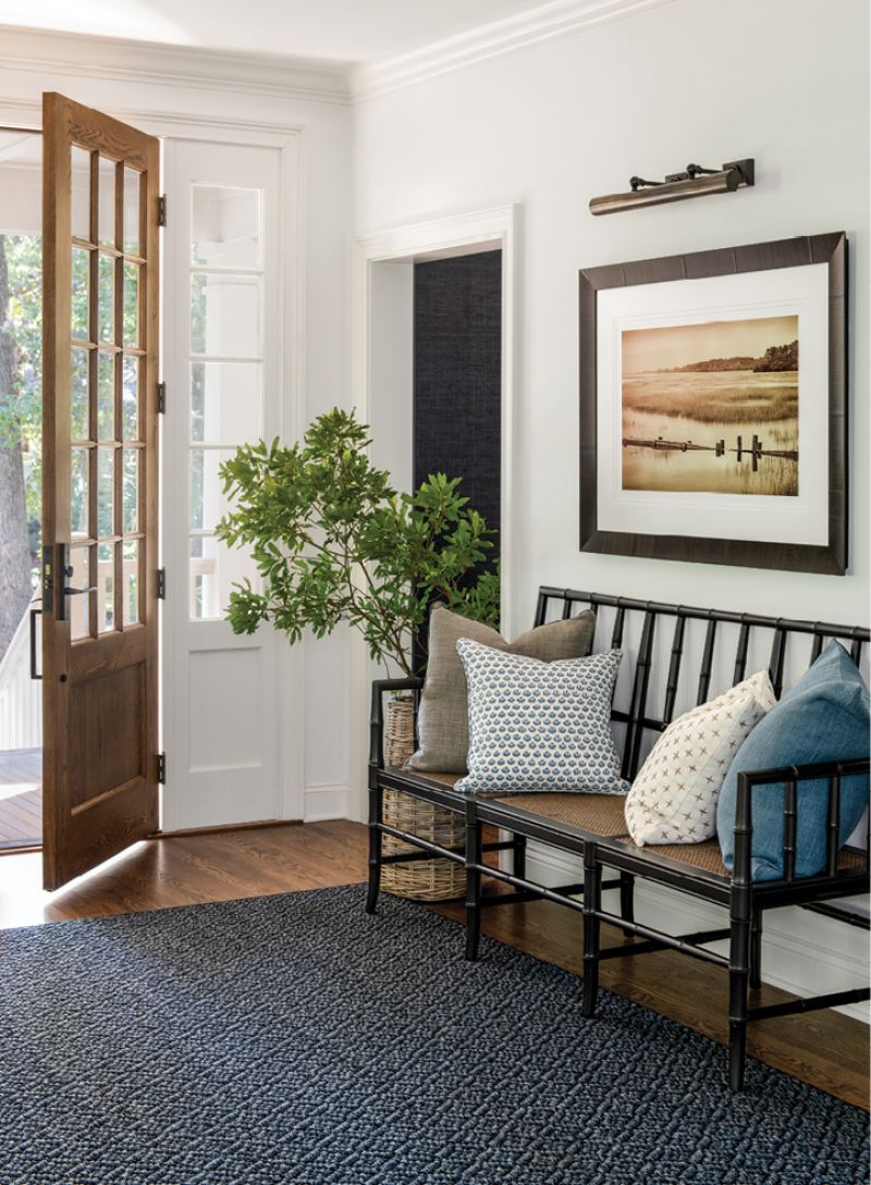 Inside, the entryway was reconfigured, adding a wall specifically designed to hang photographer Ben Ham’s marsh scene on one side and a TV on the other.